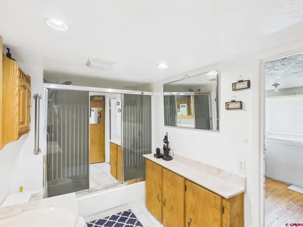 a spacious bathroom with a tub and mirror