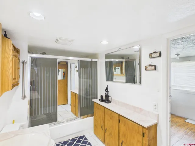 a spacious bathroom with a tub and mirror