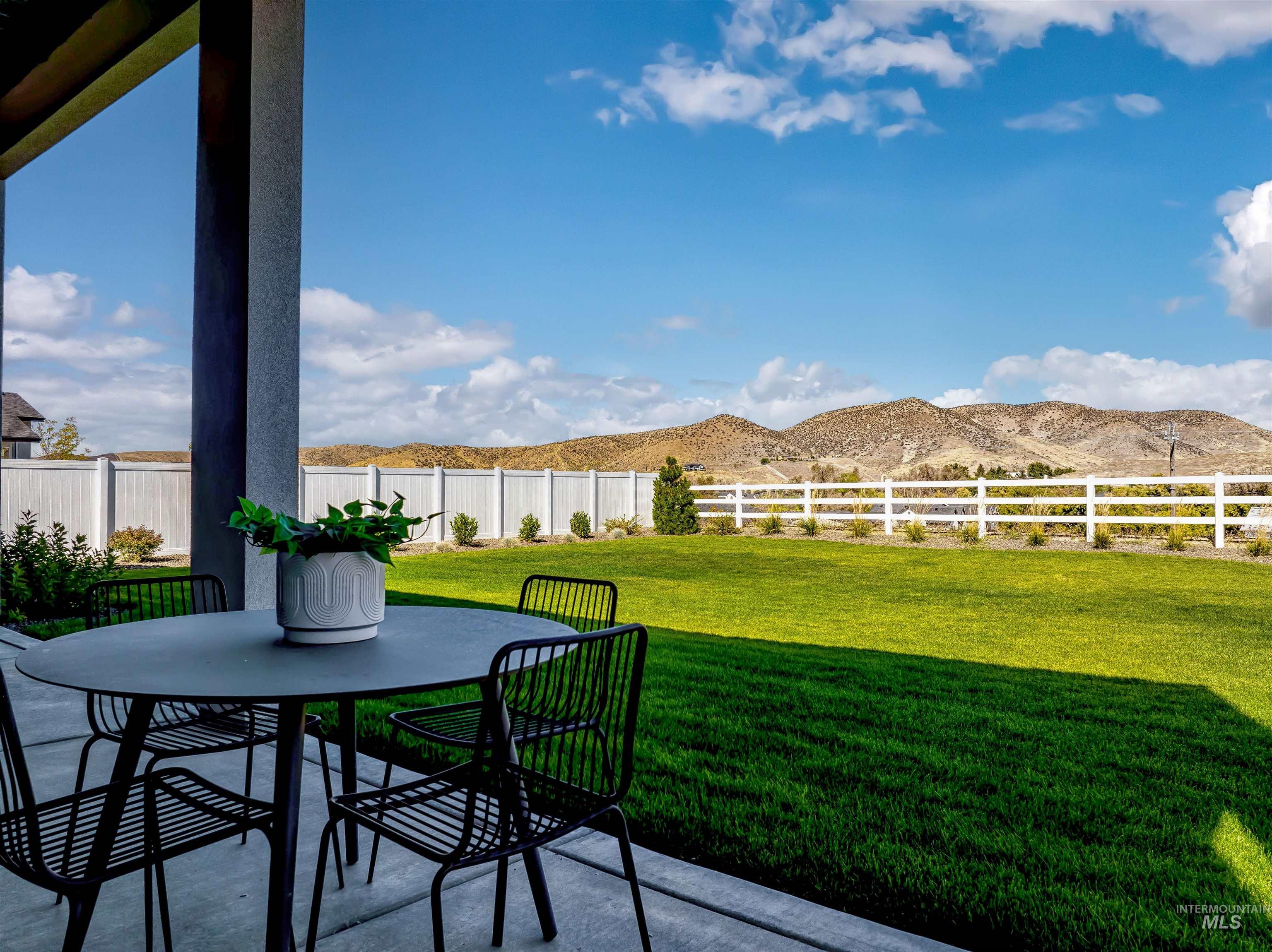 13758 North Ruffed Grouse Way Boise, ID 83714 - Photo 2 of 45 Fenced backyard featuring a patio area, outdoor dining area, and a mountain view