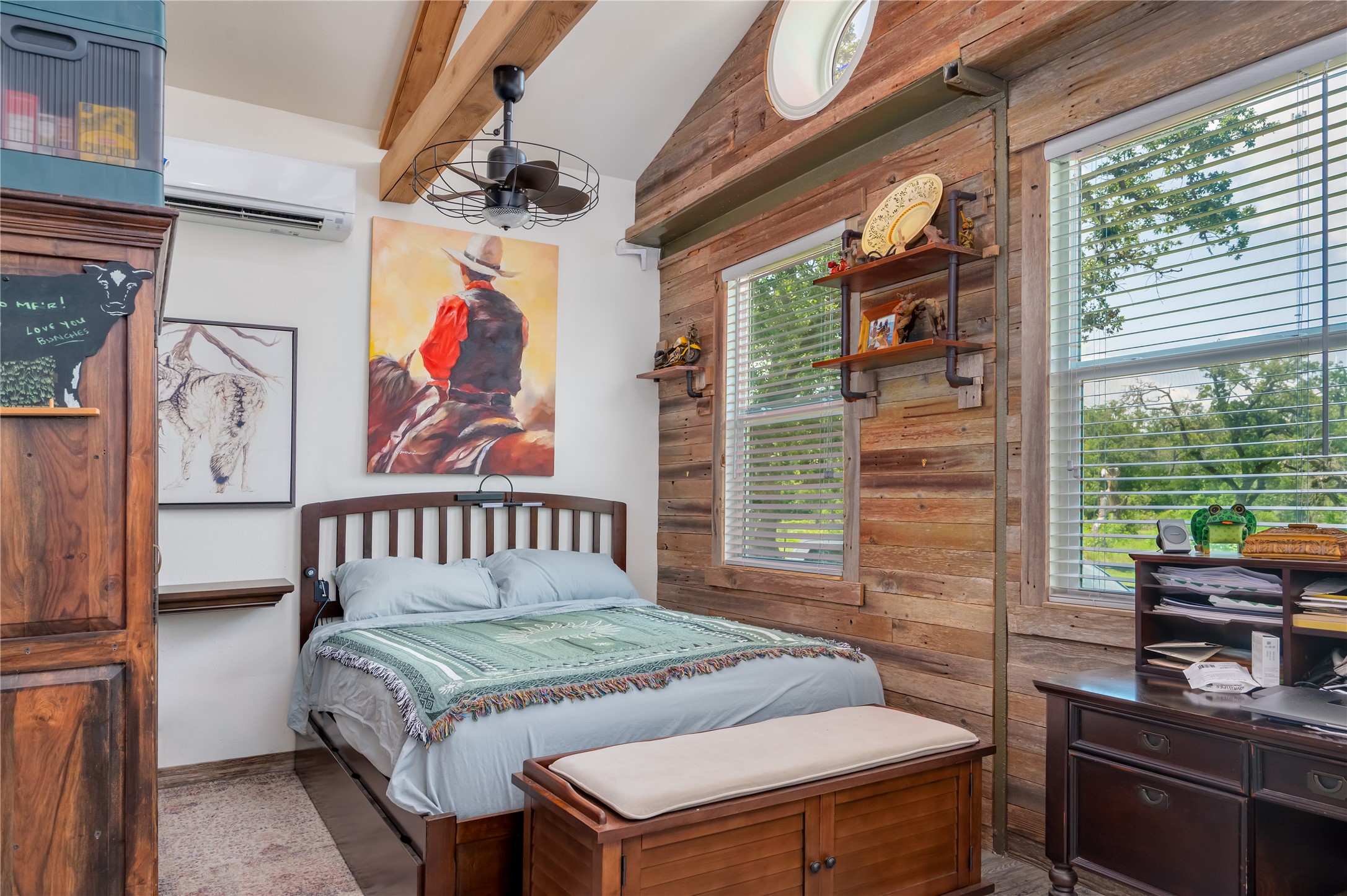 270 Dry Creek Road Manor, TX 78653 - Photo 31 of 40 A rustic retreat, this bedroom features wooden accents, exposed beams, and naturally illuminated by multiple windows.