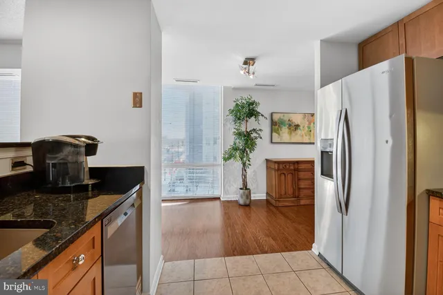 a kitchen with granite countertop a refrigerator and a stove