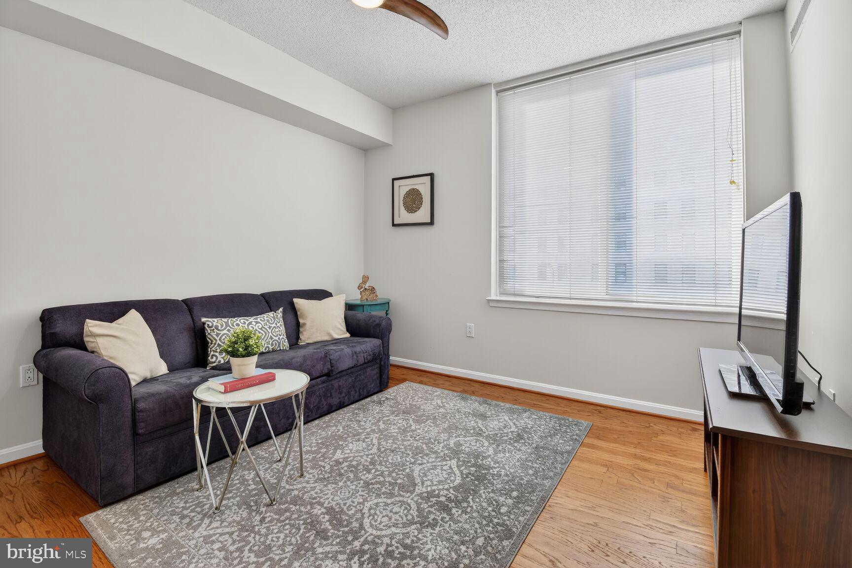 930 Wayne Avenue, Unit 405 Silver Spring, MD 20910 - Photo 19 of 37 a living room with furniture and a window