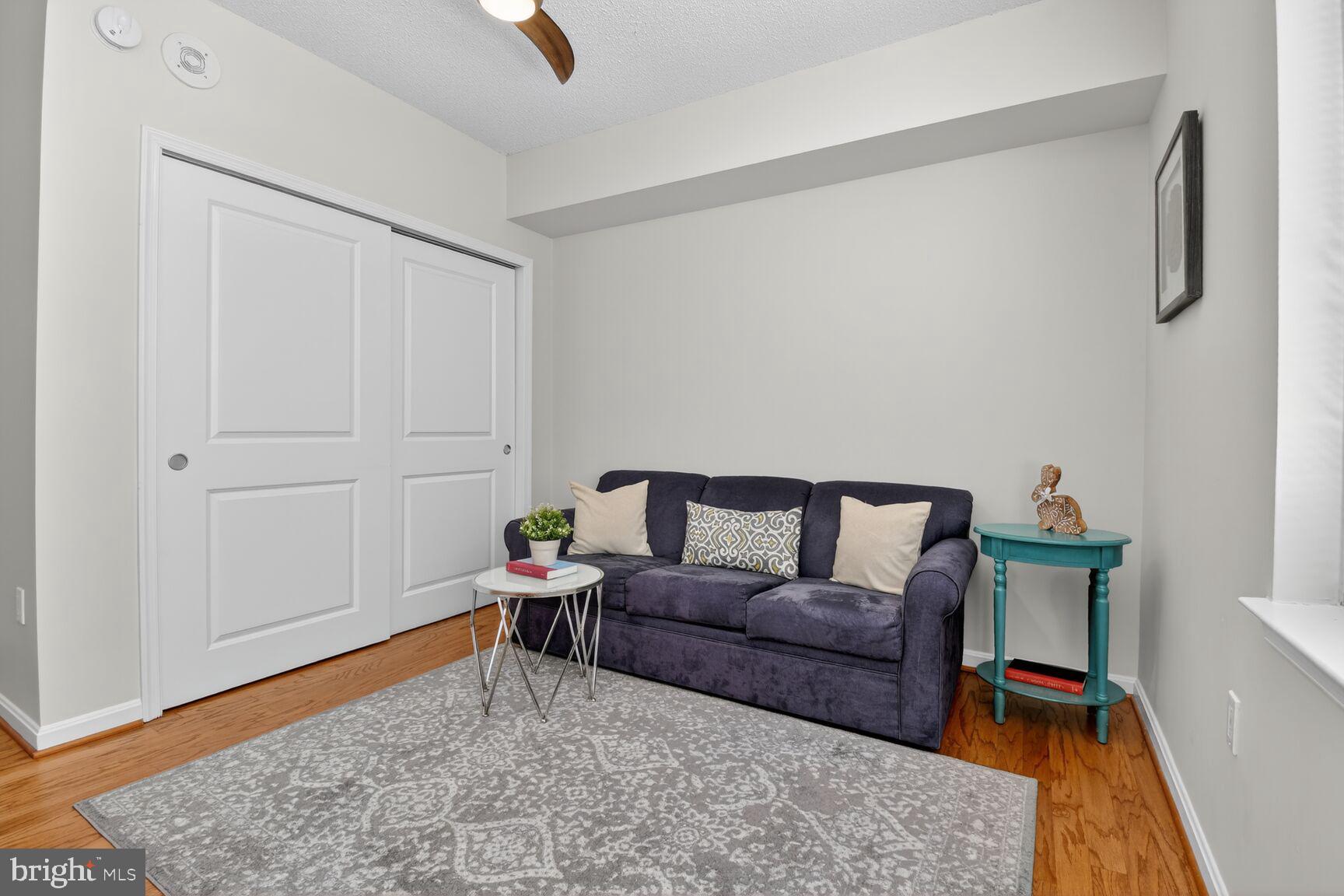 930 Wayne Avenue, Unit 405 Silver Spring, MD 20910 - Photo 20 of 37 a living room with furniture and a rug