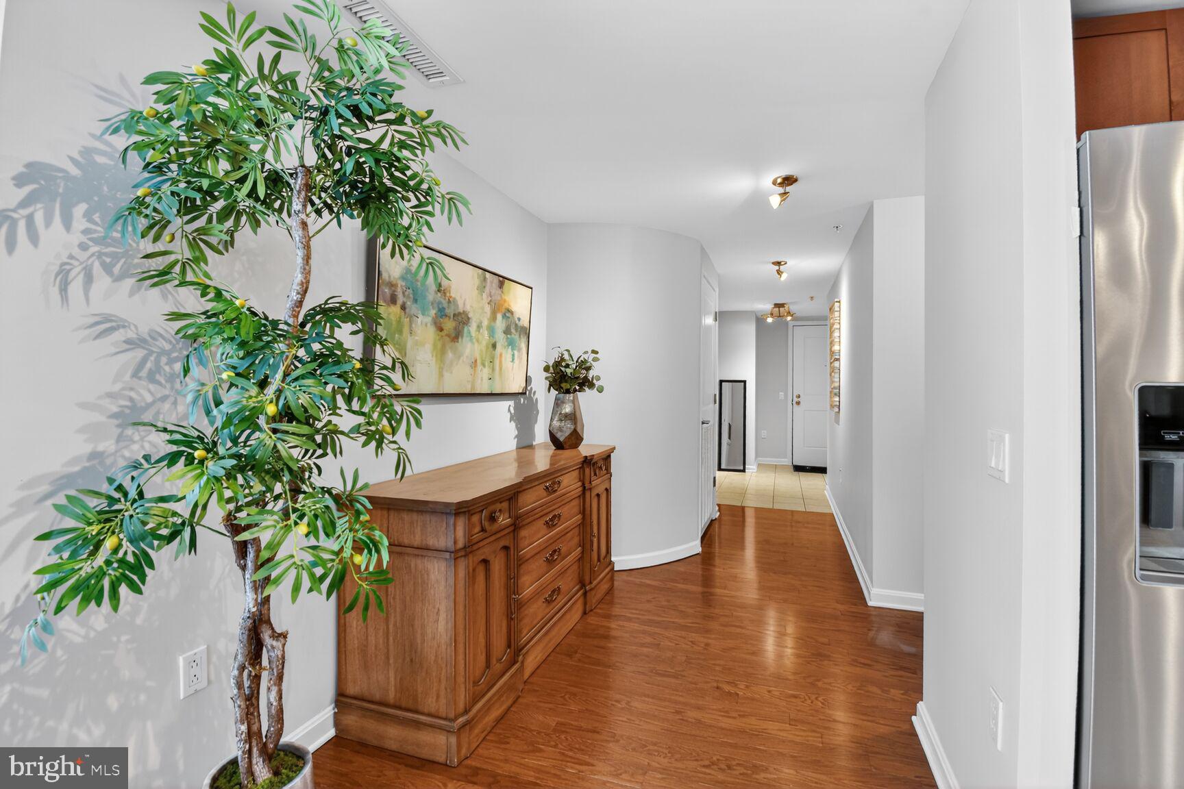 930 Wayne Avenue, Unit 405 Silver Spring, MD 20910 - Photo 22 of 37 view of a hallway with wooden floor and a potted plant