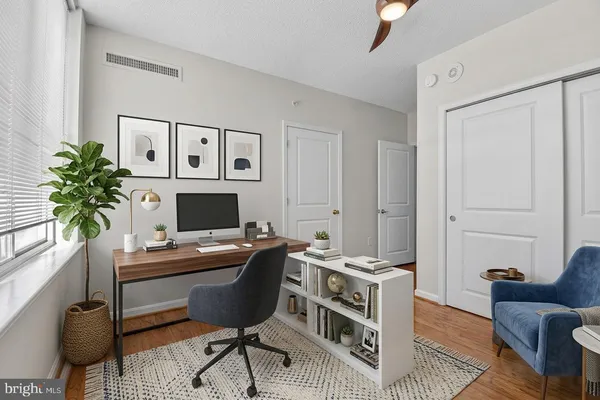 view of a hallway with wooden floor and a potted plant