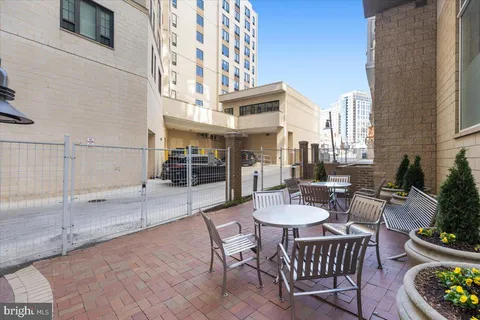 a view of a patio with couches table and chairs and potted plants
