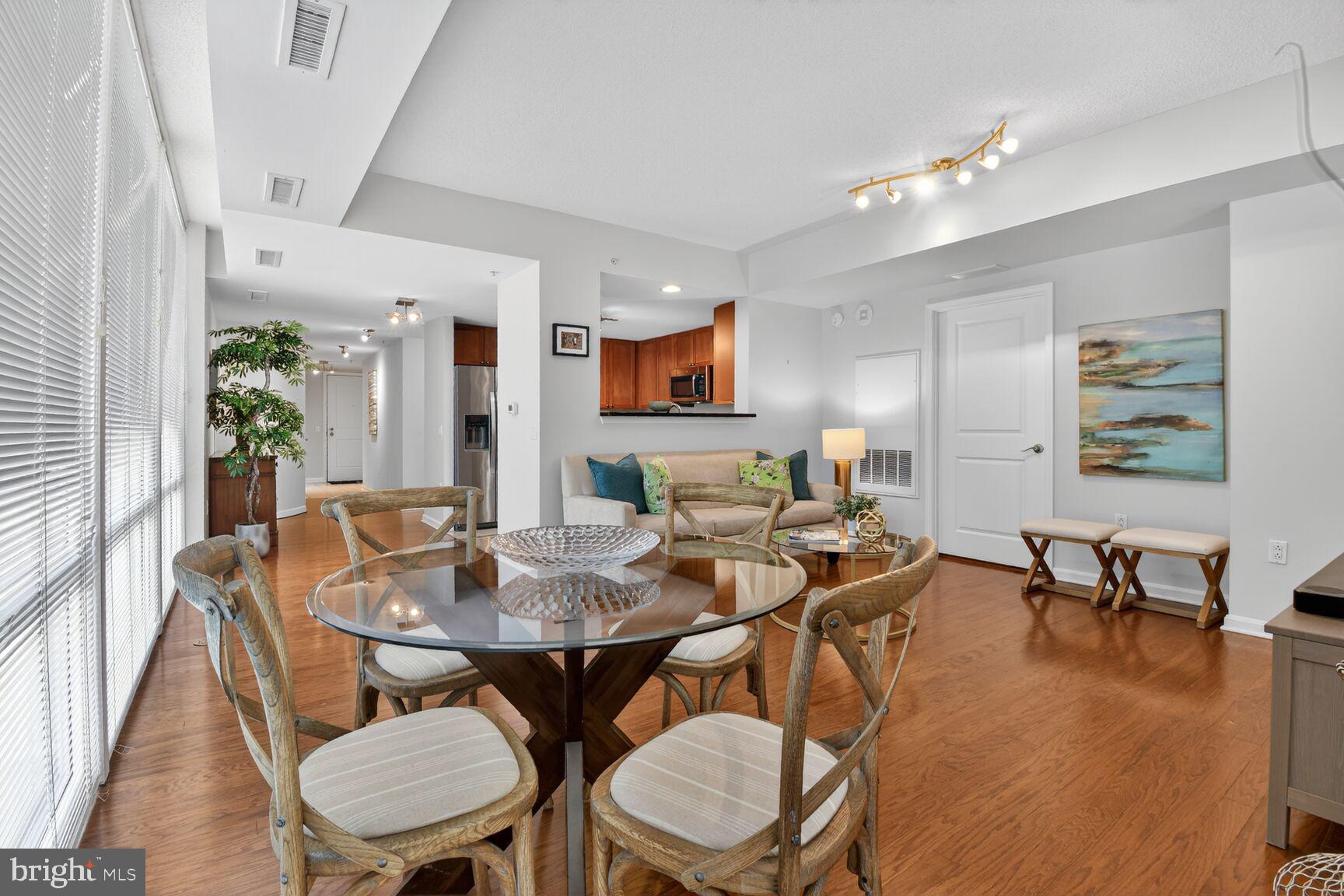 930 Wayne Avenue, Unit 405 Silver Spring, MD 20910 - Photo 10 of 37 a view of a dining room with furniture and wooden floor