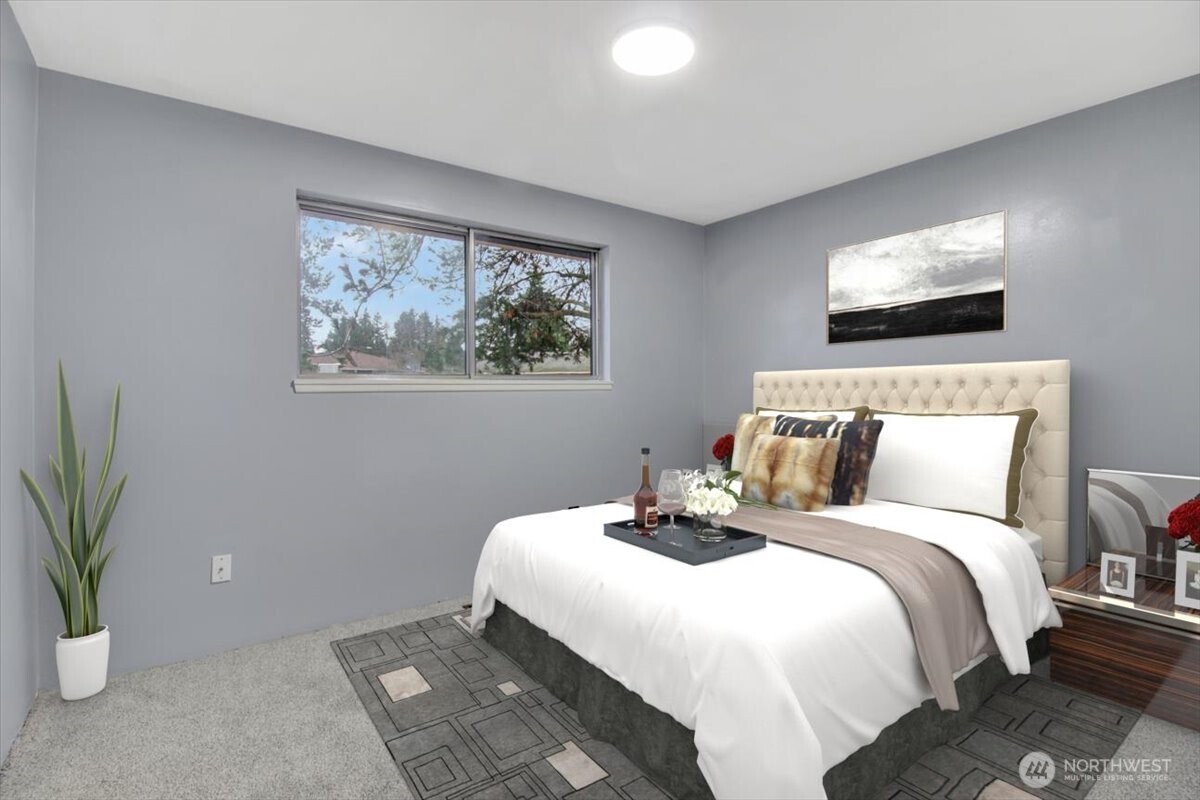 7313 228th Street Southwest Mountlake Terrace, WA 98043 - Photo 14 of 34 a bedroom with bed and a potted plant