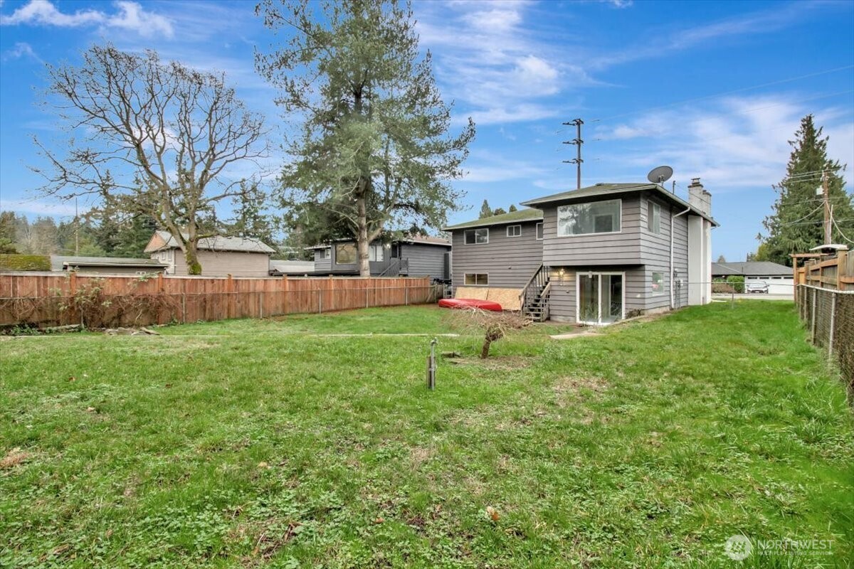 7313 228th Street Southwest Mountlake Terrace, WA 98043 - Photo 31 of 34 a front view of a house with garden