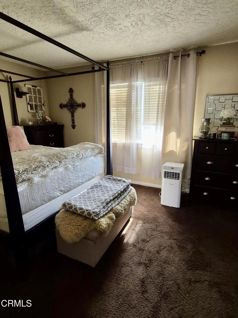 312 West Santa Barbara Street Santa Paula, CA 93060 - Photo 12 of 22 a bedroom with a bed and wooden floor