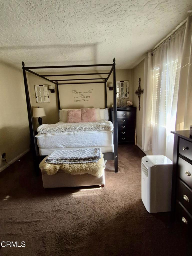 312 West Santa Barbara Street Santa Paula, CA 93060 - Photo 14 of 22 a bedroom with a bed and a couch