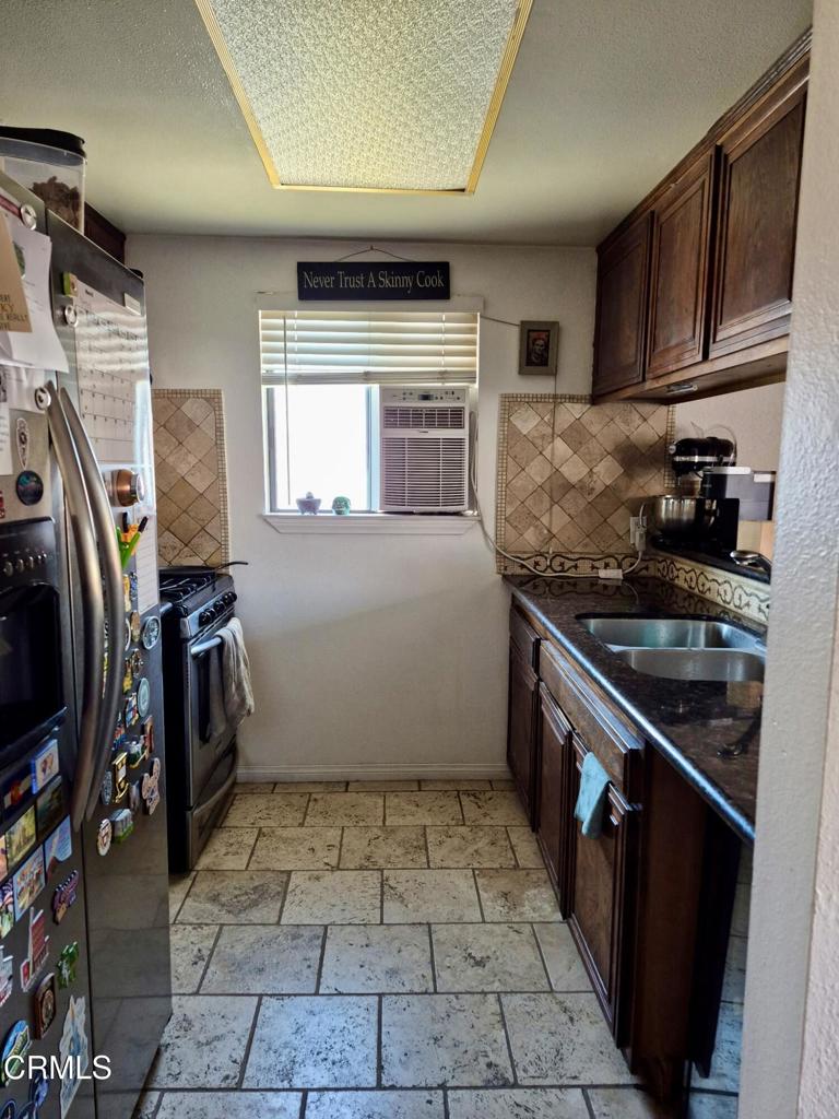 312 West Santa Barbara Street Santa Paula, CA 93060 - Photo 8 of 22 a kitchen with a sink a stove top oven and cabinets