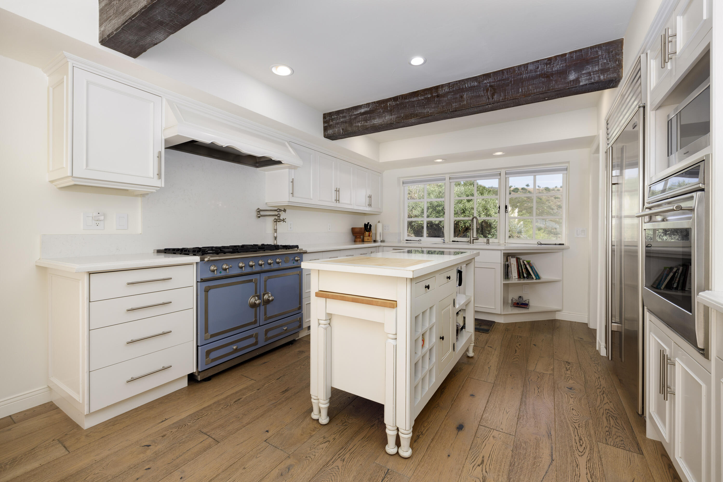 1230 Northridge Road Santa Barbara, CA 93105 - Photo 12 of 36 a kitchen with stainless steel appliances a white stove top oven cabinets a sink and a window