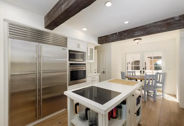a kitchen with a refrigerator a sink and a stove