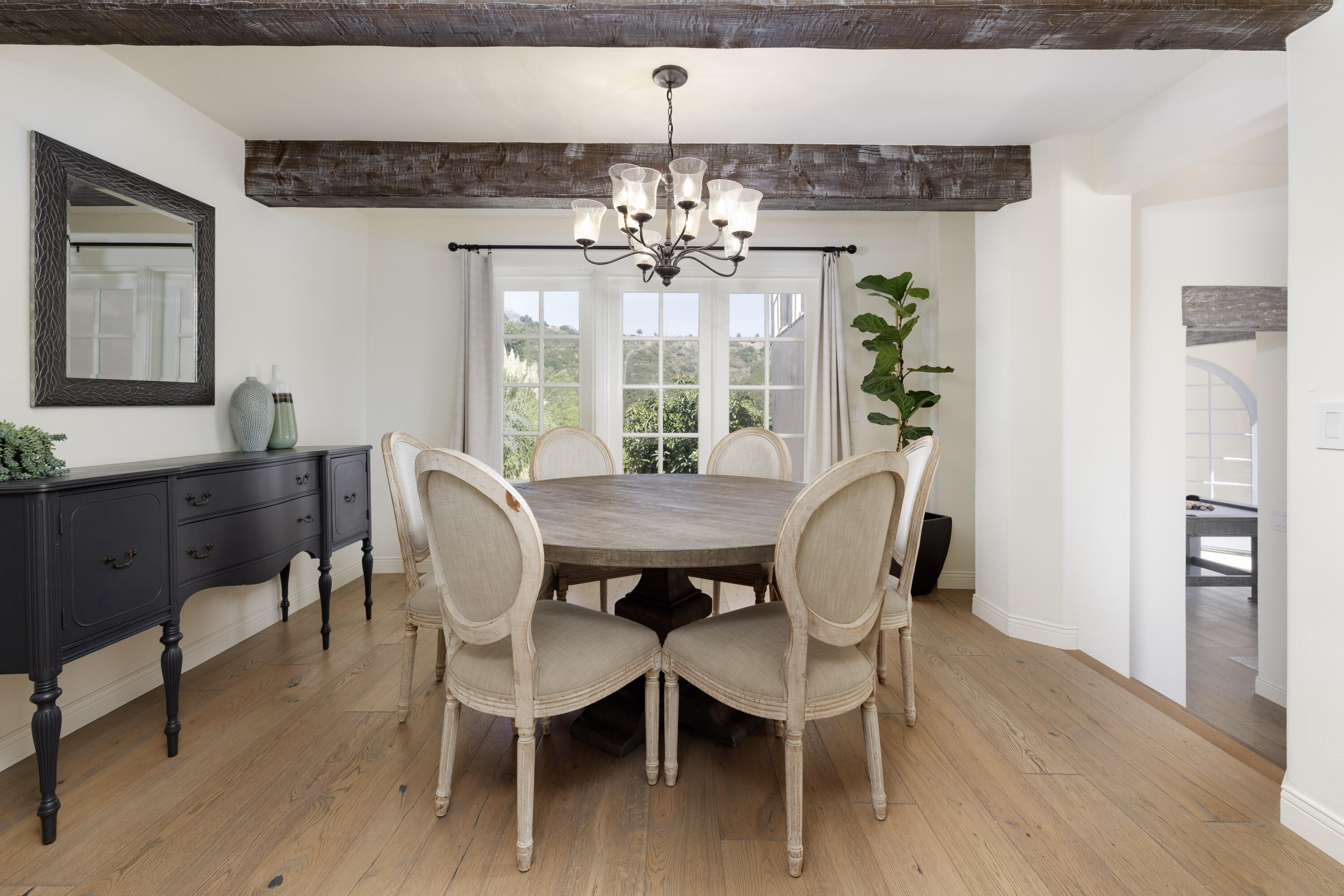 1230 Northridge Road Santa Barbara, CA 93105 - Photo 14 of 36 a view of a dining room with furniture wooden floor and chandelier