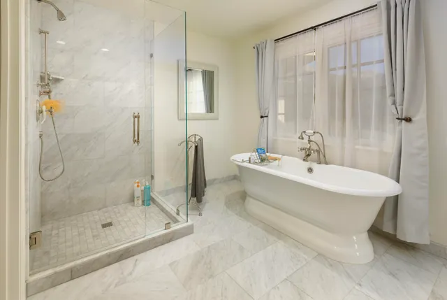 a bathroom with a bathtub and shower