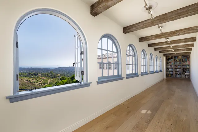 an empty room with fireplace and windows
