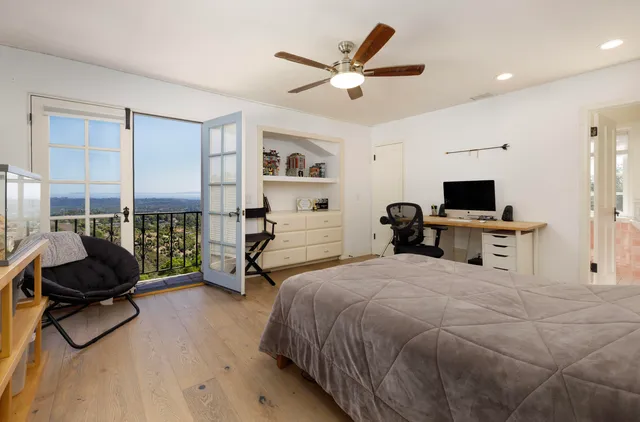 a bedroom with a bed a couch and a window