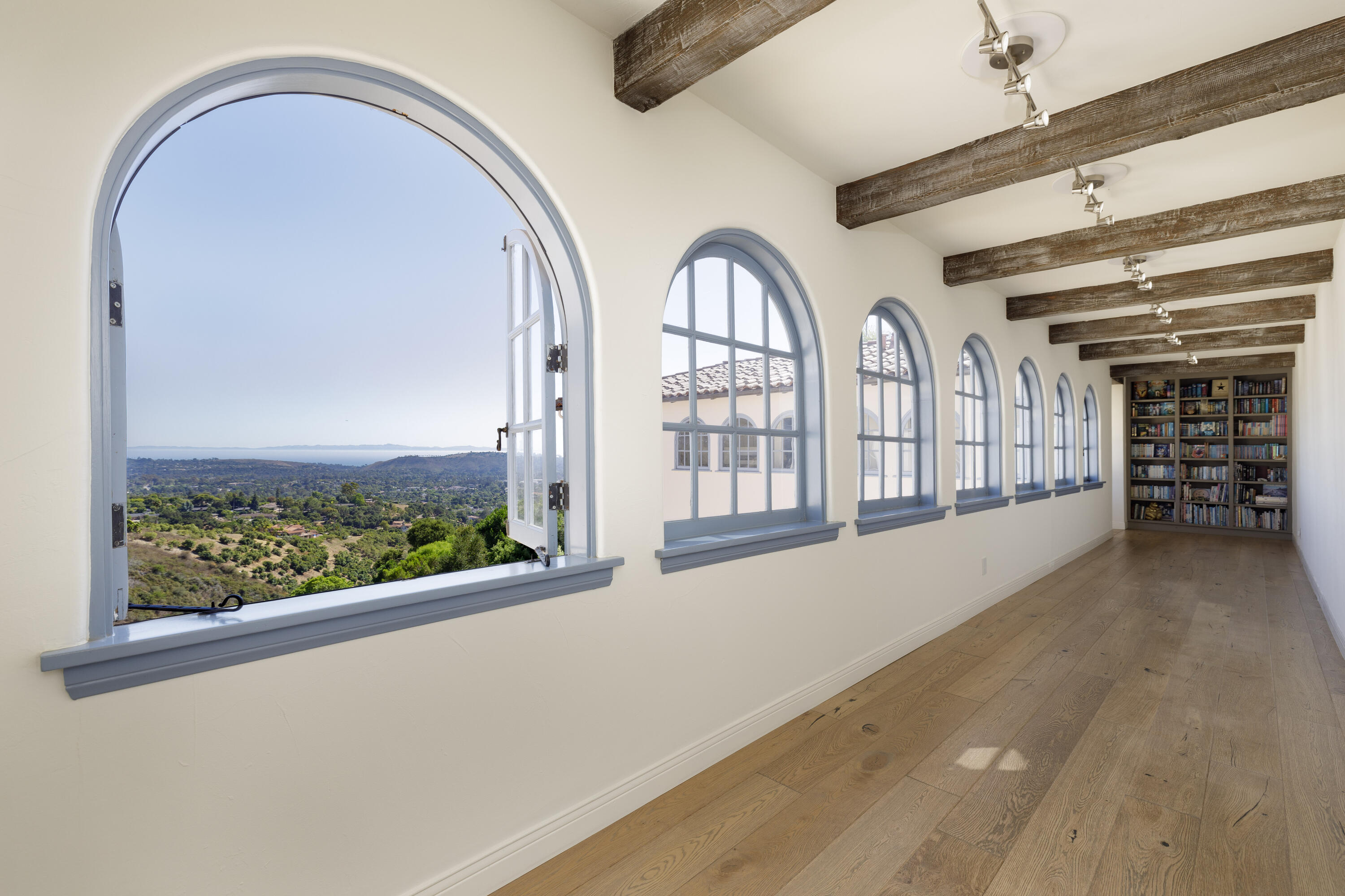 1230 Northridge Road Santa Barbara, CA 93105 - Photo 22 of 36 an empty room with fireplace and windows