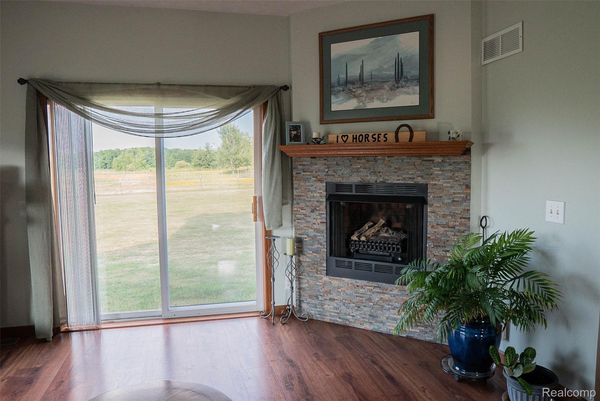1155 Morris Road Lapeer, MI 48446 - Photo 15 of 47 Natural gas fireplace and sliding back door.