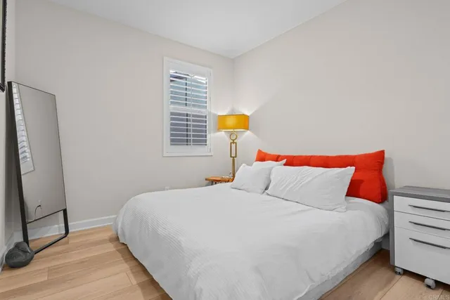 a bedroom with a bed and a window