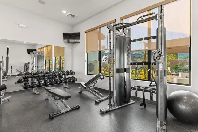 a living room with furniture and floor to ceiling window