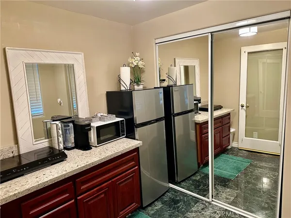 a kitchen with refrigerator and mirror