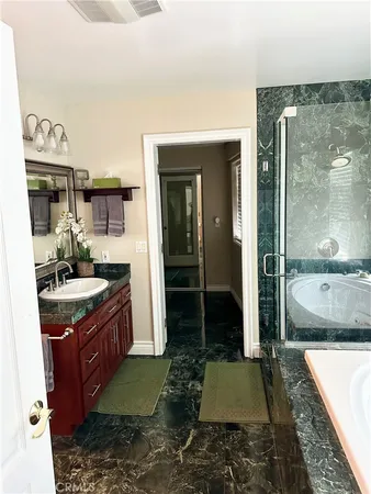a bathroom with a granite countertop sink and a mirror