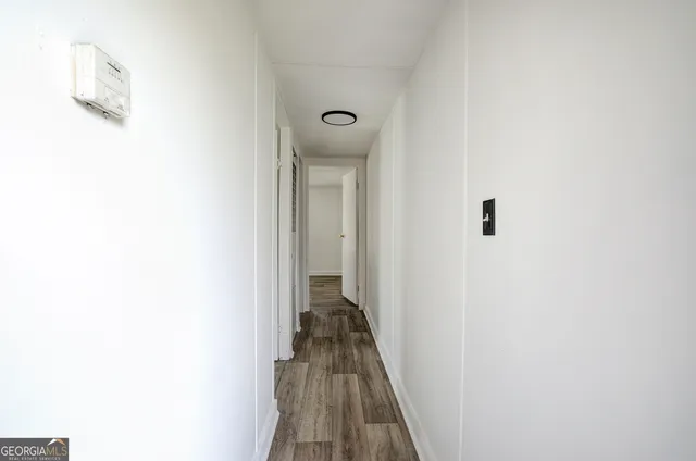 a view of a hallway with wooden floor