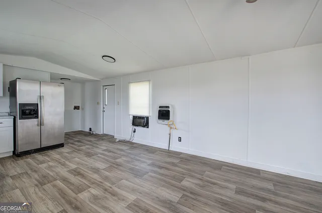 a big room with wooden floor and windows