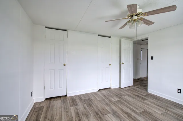 a view of an empty room with a fan