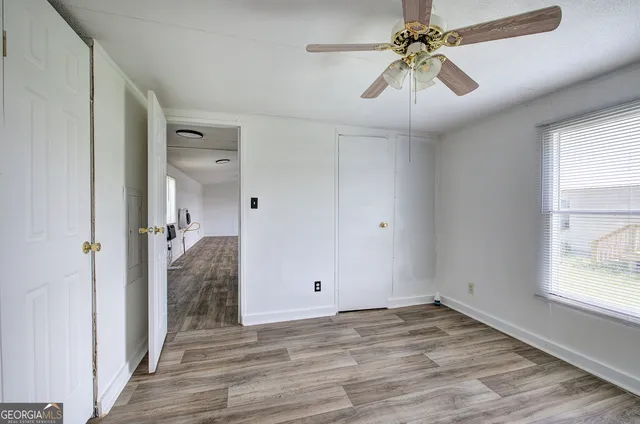 wooden floor in an empty room with a window