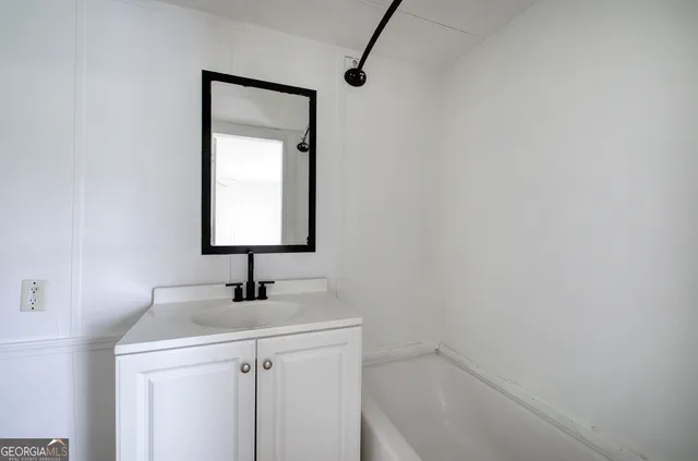 a bathroom with a sink a vanity and a mirror