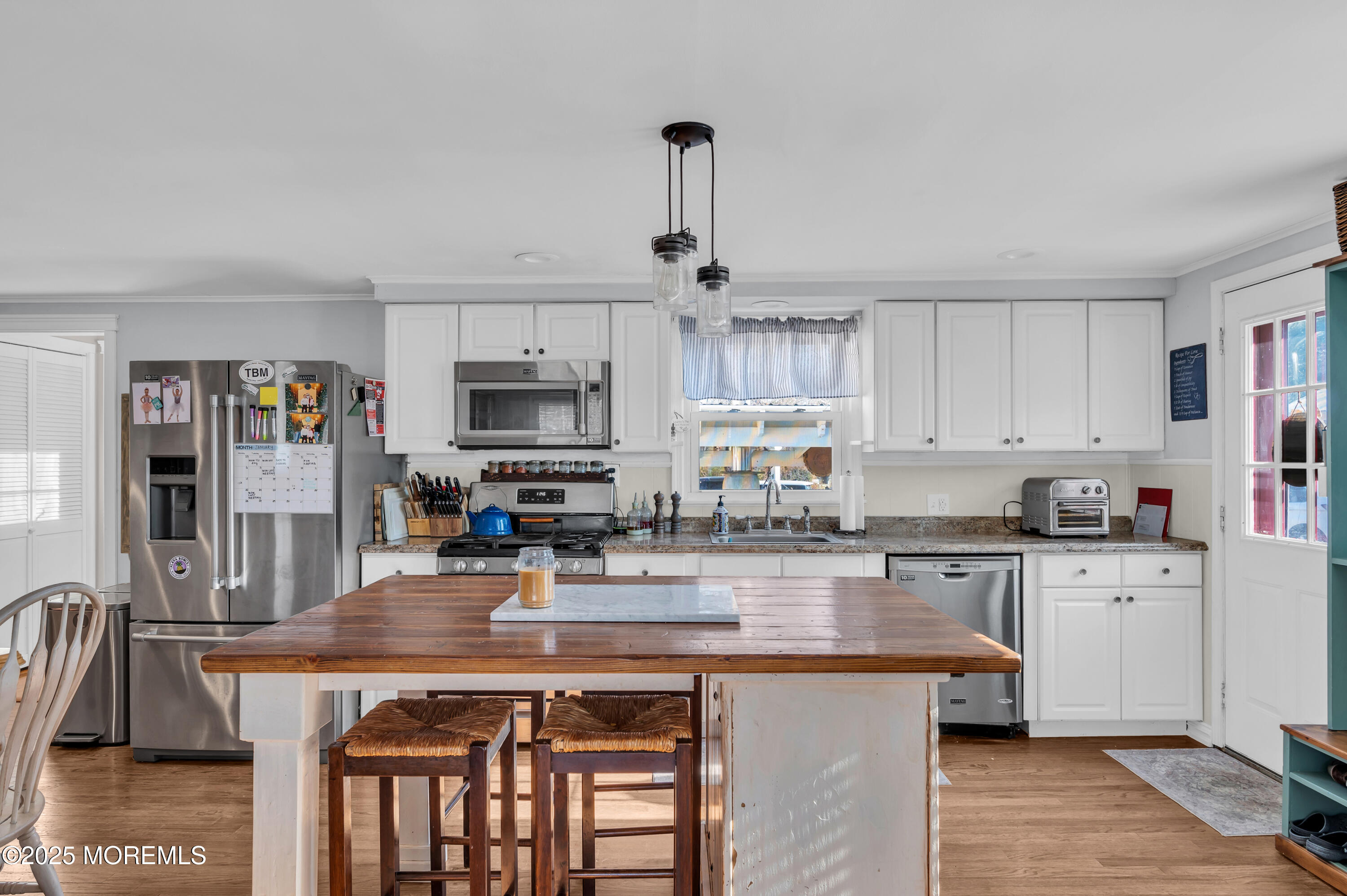 1830 New Bedford Road Wall, NJ 07719 - Photo 20 of 65 a kitchen with stainless steel appliances granite countertop a stove top oven a refrigerator a sink dishwasher and white cabinets with wooden floor