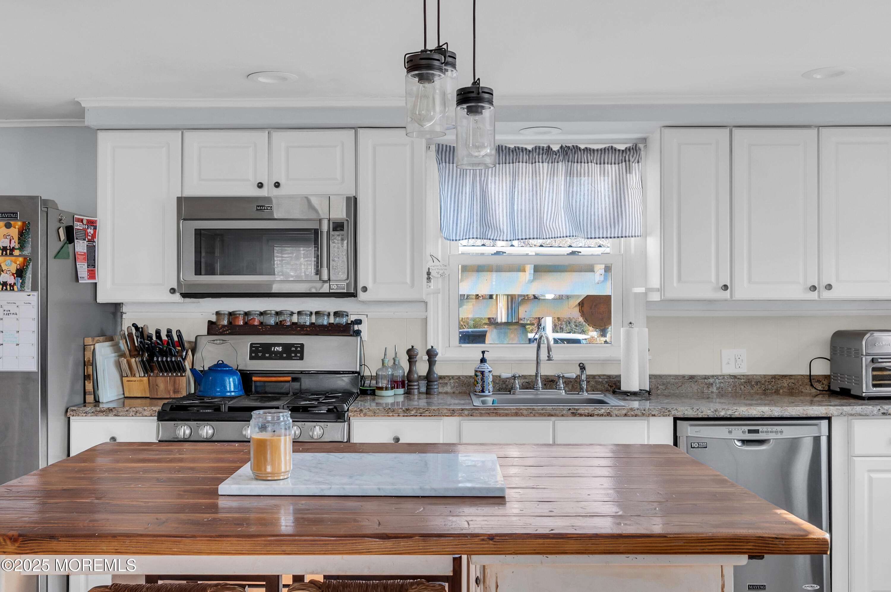 1830 New Bedford Road Wall, NJ 07719 - Photo 21 of 65 a kitchen with kitchen island granite countertop a stove top oven a sink a counter space and cabinets