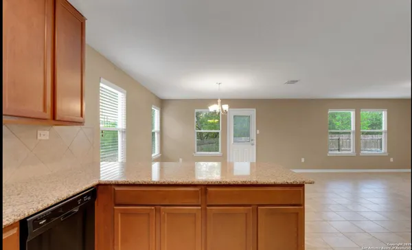 a view of a kitchen with a sink and windows