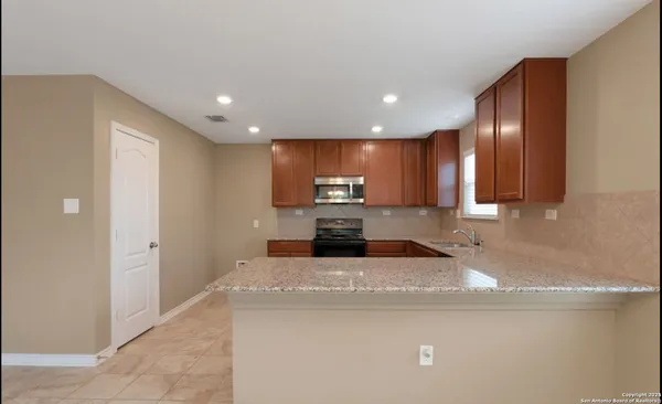a view of a kitchen with a sink and dishwasher
