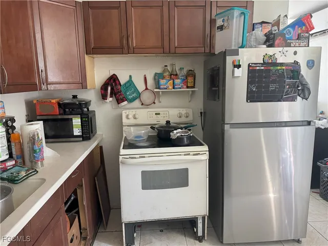 a kitchen with stainless steel appliances a stove a refrigerator and cabinets