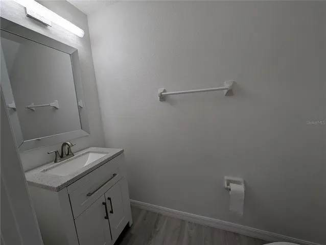 a bathroom with a sink and vanity