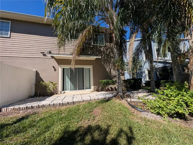 a view of a house with a small yard and a garden