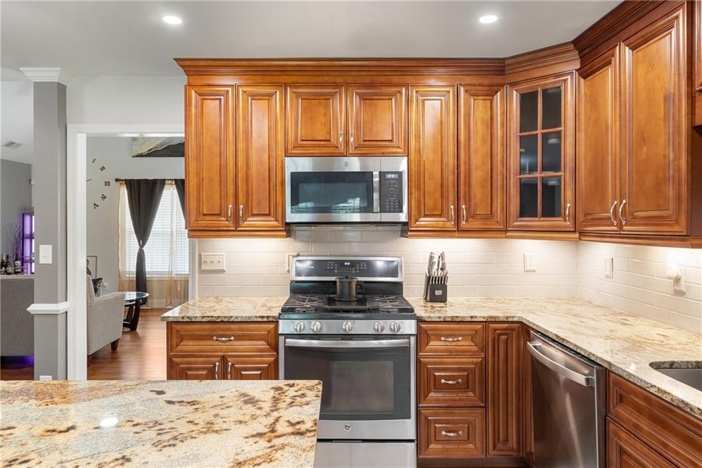 55 Meridian Point Dallas, GA 30132 - Photo 11 of 45 a kitchen with stainless steel appliances granite countertop a stove microwave and cabinets