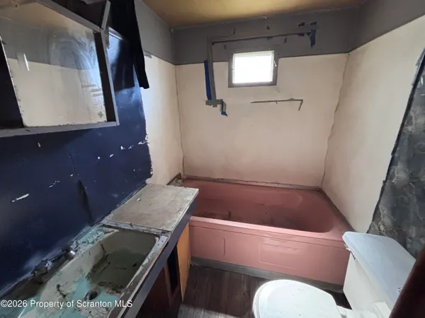 a room with a wooden floor and furniture