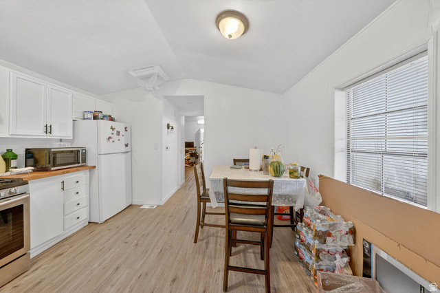 262 Hidden View Drive, Unit 94 Sandy, UT 84070 - Photo 6 of 18 Dining area featuring lofted ceiling and light wood finished floors