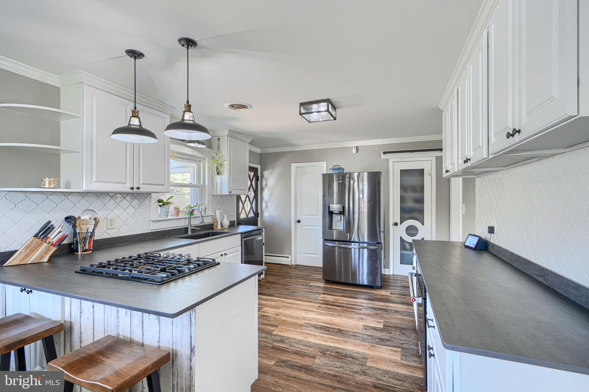 1314 East Churchville Road Bel Air, MD 21014 - Photo 15 of 48 a kitchen with stainless steel appliances granite countertop a stove and a refrigerator