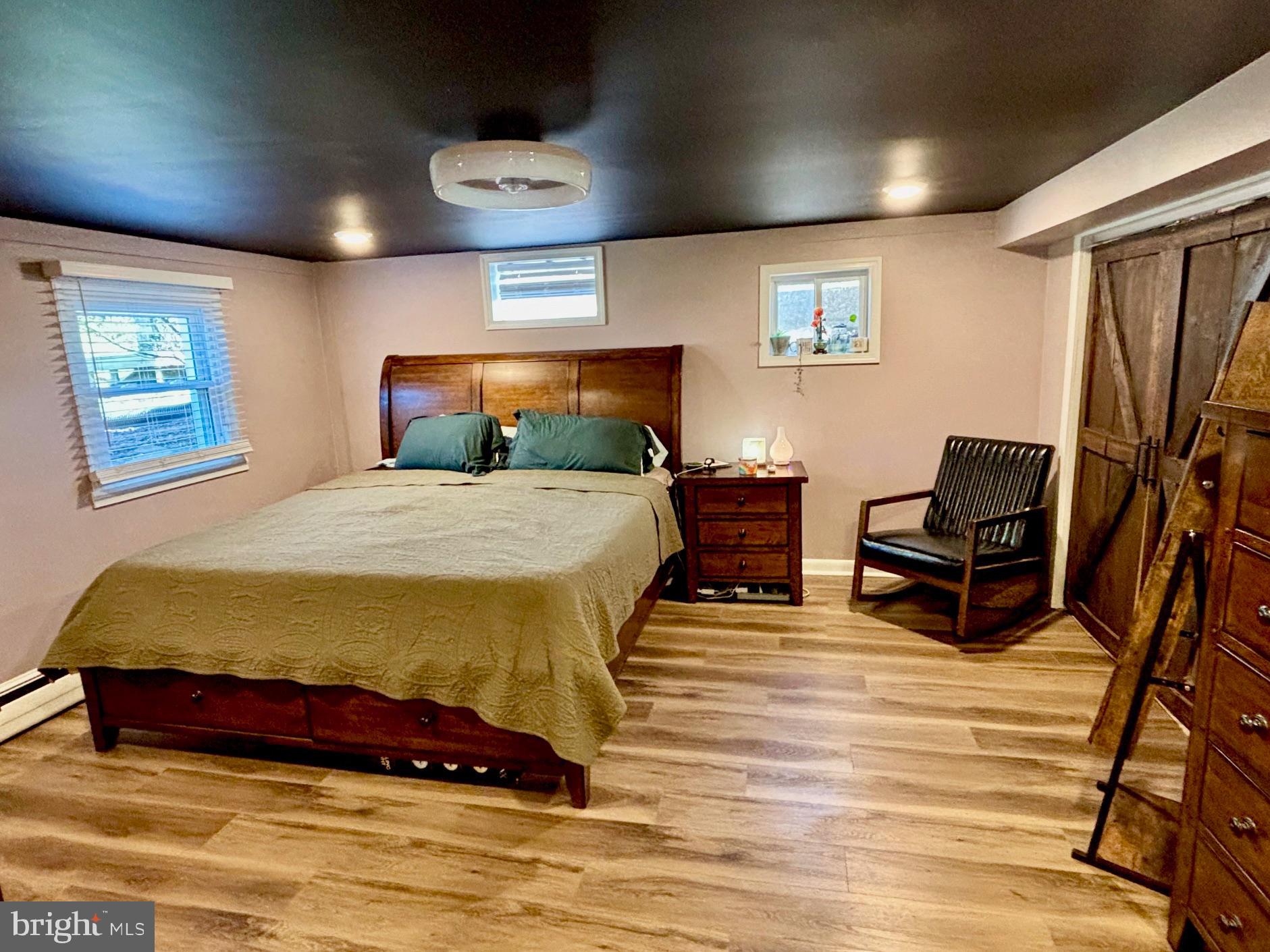 1314 East Churchville Road Bel Air, MD 21014 - Photo 21 of 48 a spacious bedroom with a bed and a chandelier