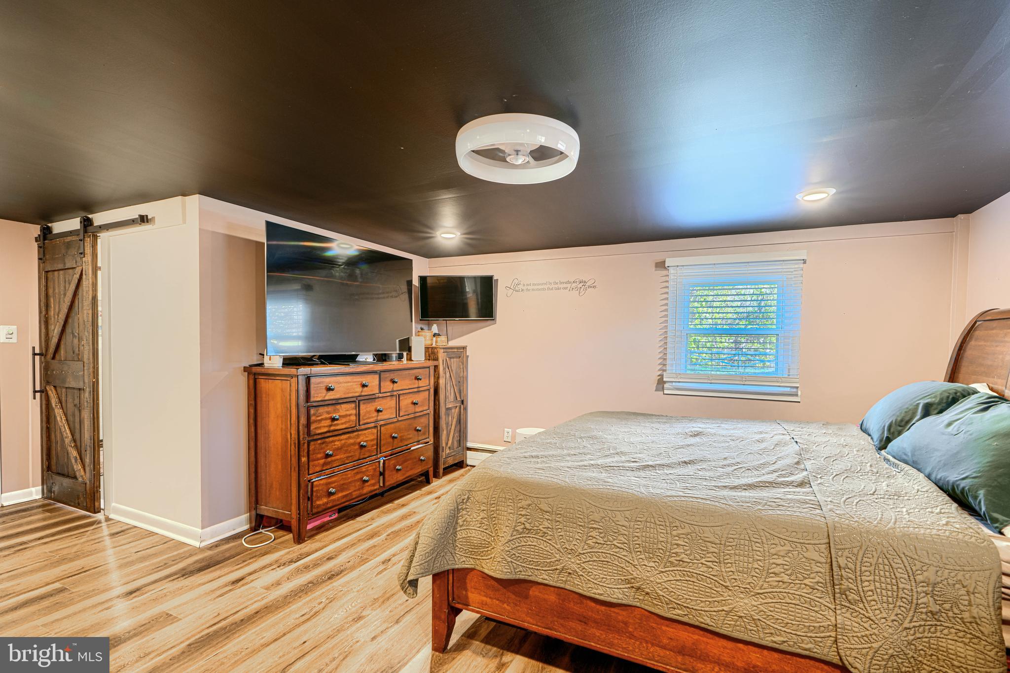 1314 East Churchville Road Bel Air, MD 21014 - Photo 22 of 48 a bedroom with a bed and a flat screen tv