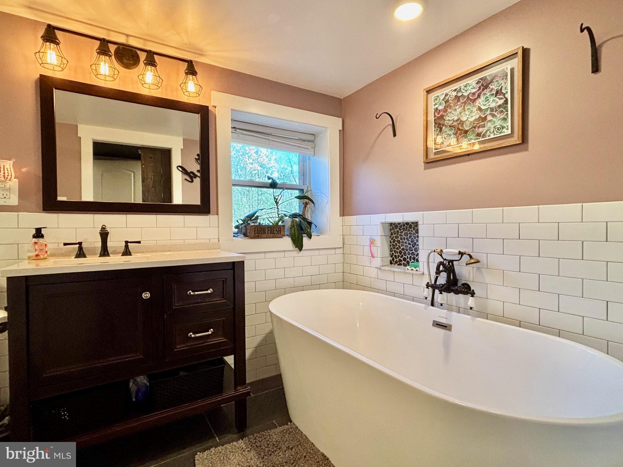 1314 East Churchville Road Bel Air, MD 21014 - Photo 26 of 48 a bathroom with a tub sink and mirror