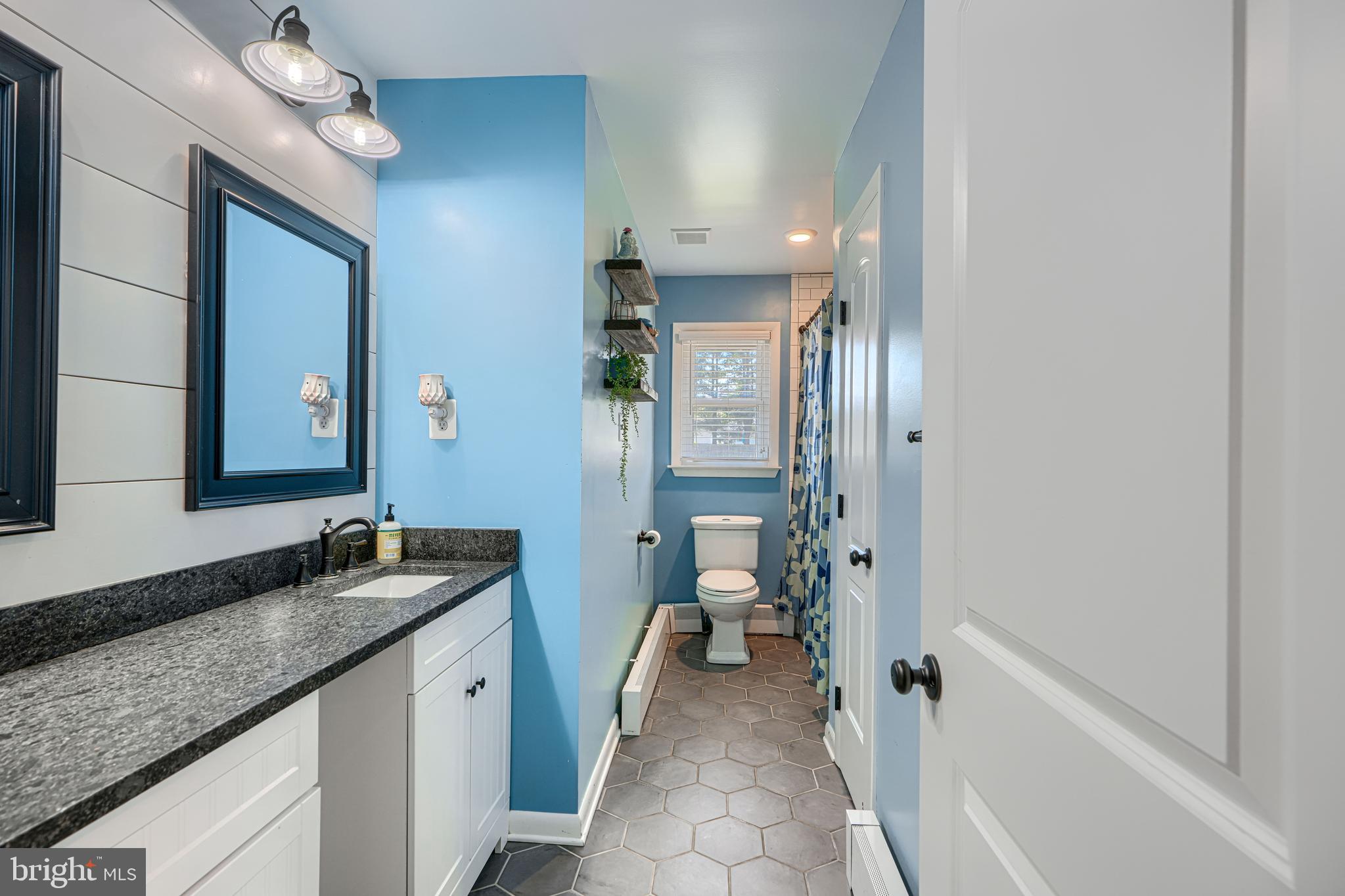 1314 East Churchville Road Bel Air, MD 21014 - Photo 32 of 48 a spacious bathroom with a granite countertop sink a mirror and a bathtub