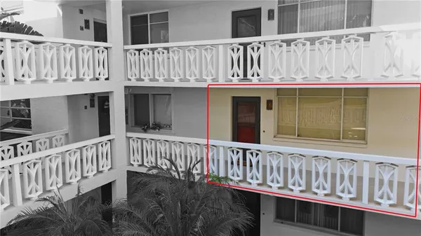 a view of a wooden house with a wooden fence