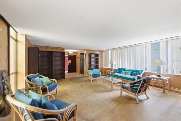 a living room with furniture and a large window